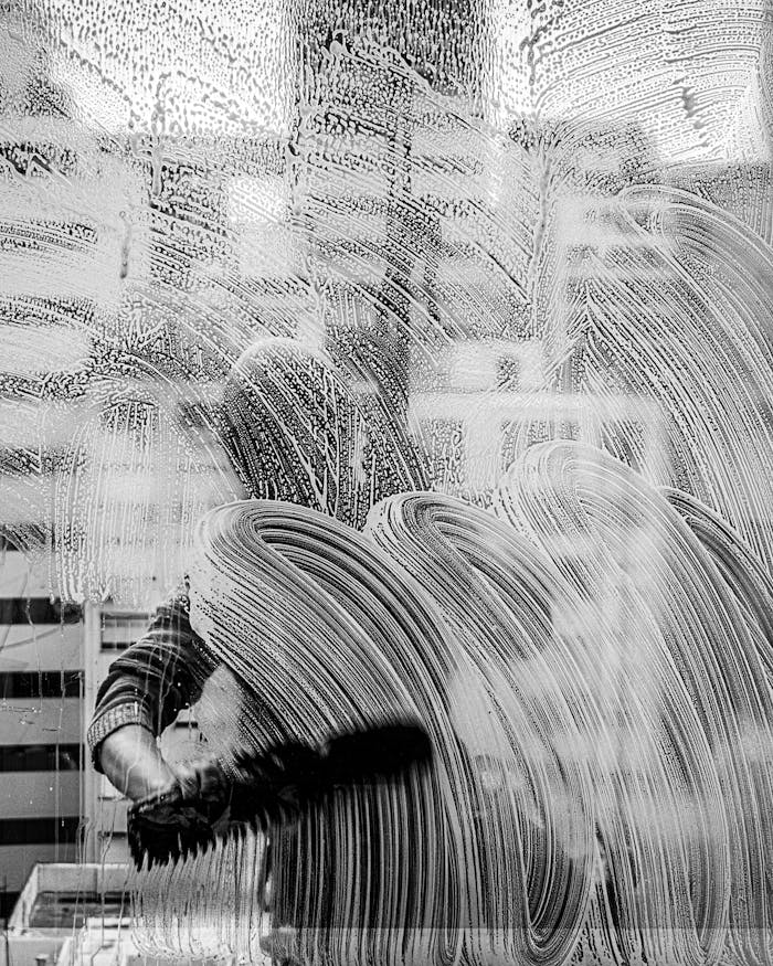 Monochrome image of a window cleaners hand in Buenos Aires, Argentina.